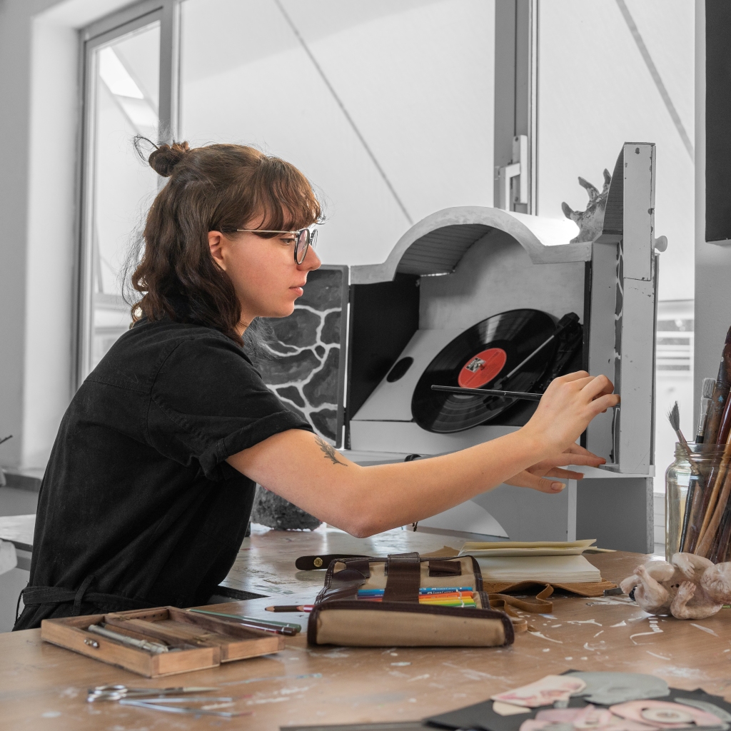 Kayla Cerrone working on a vinyl player artwork design